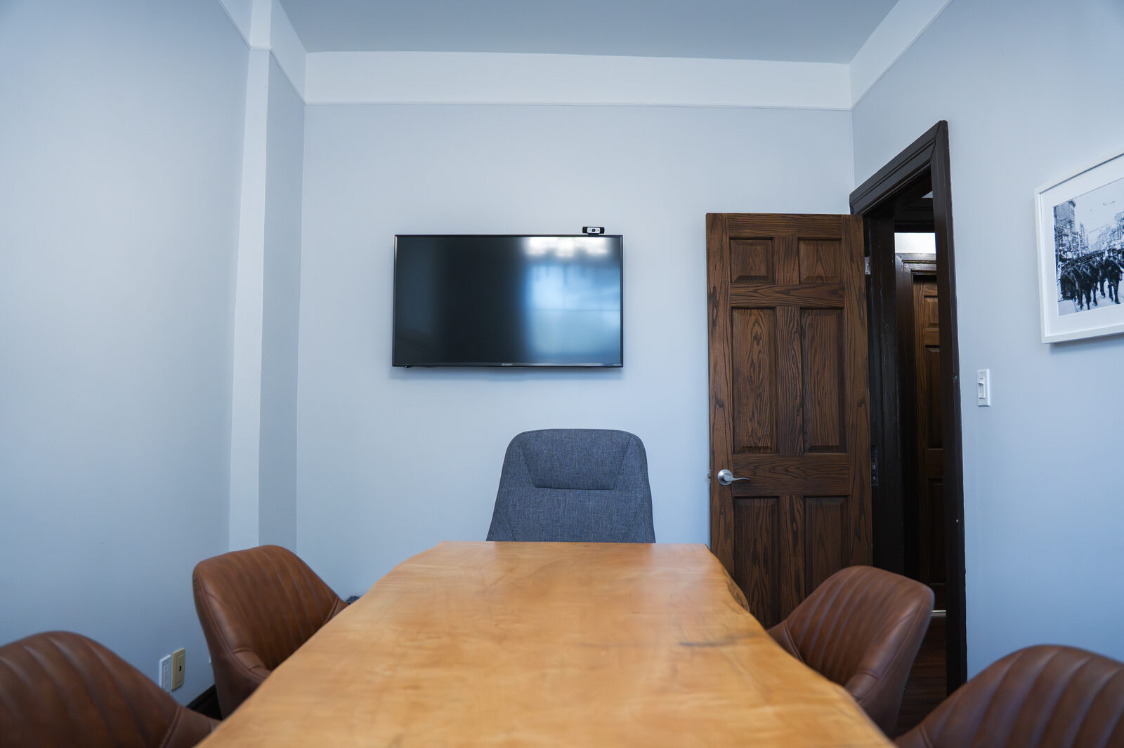 Boardroom with live-edge table and wall display