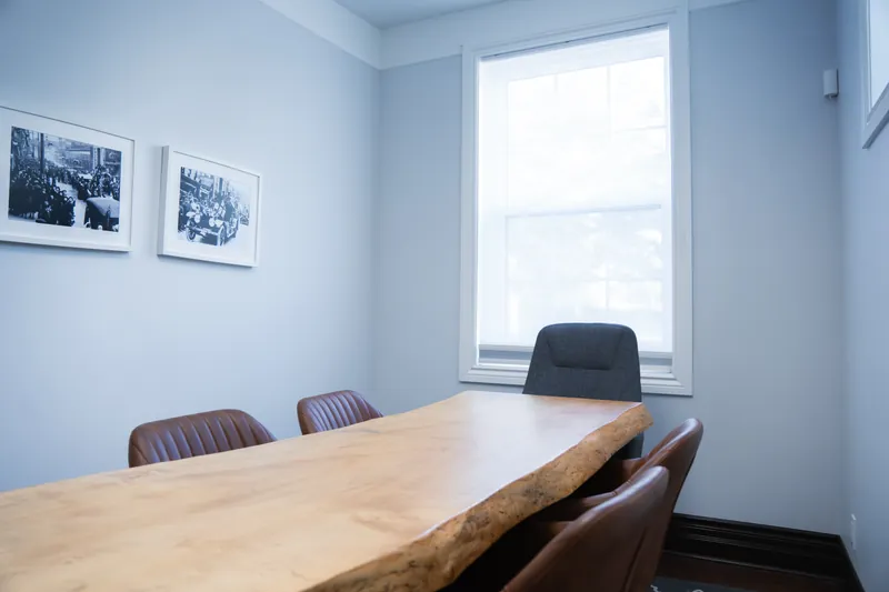 Live-edge boardroom table beside a window
