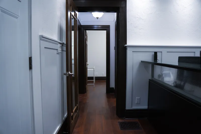 Hardwood corridor with dark wood trim